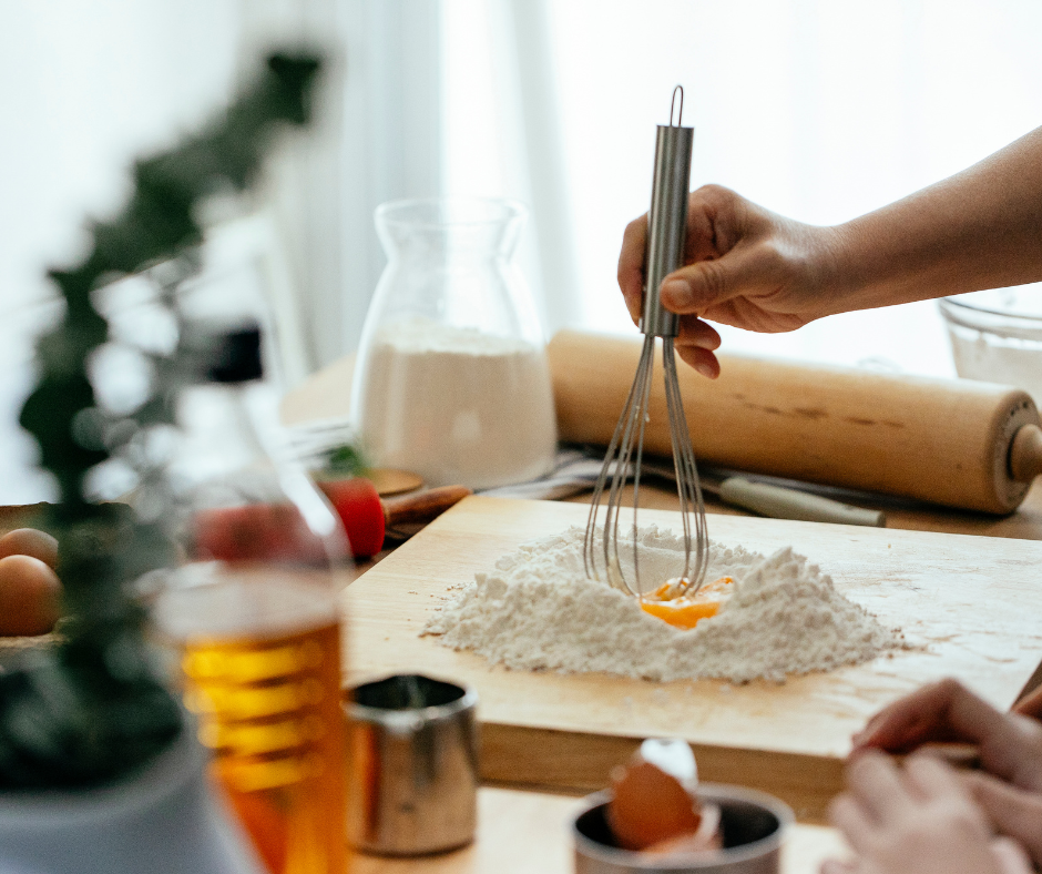 A hand mixing some pasta dough in a kitchen. A mixture of flour and eggs. 